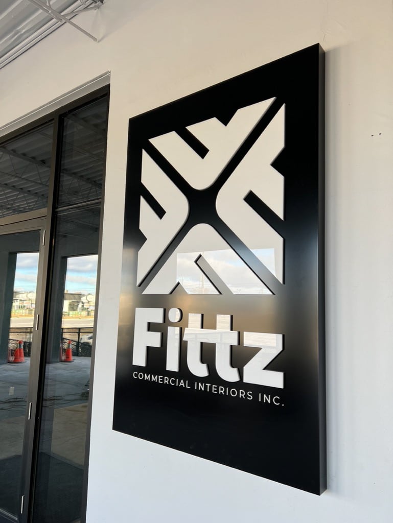 High-contrast black and white dimensional exterior signage for Fittz Commercial Interiors.